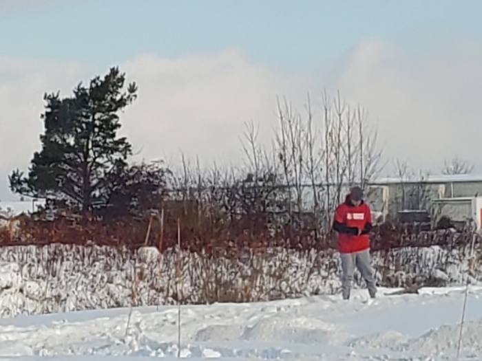 man standing in snow on cold winter day