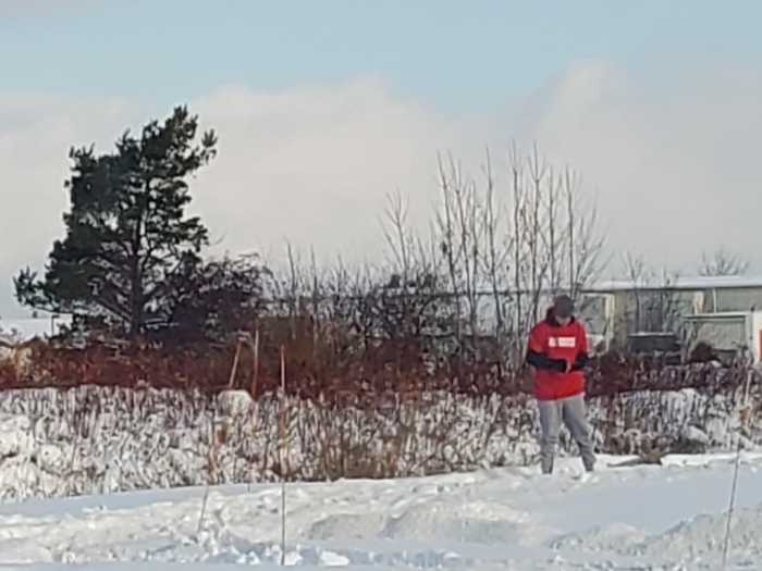 man standing in snow on cold winter day